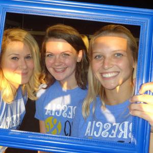Students holding a blue frame